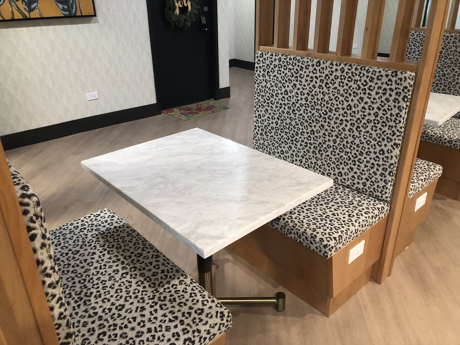 Leopard-print booth and bench seating completed as a custom upholstery project